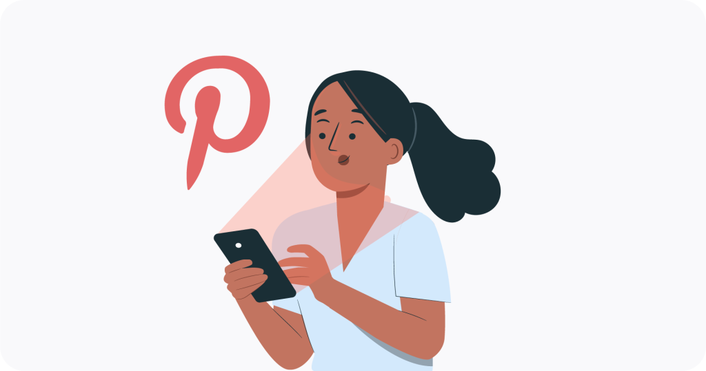 A person looking at a phone with a Pinterest logo to the side. 